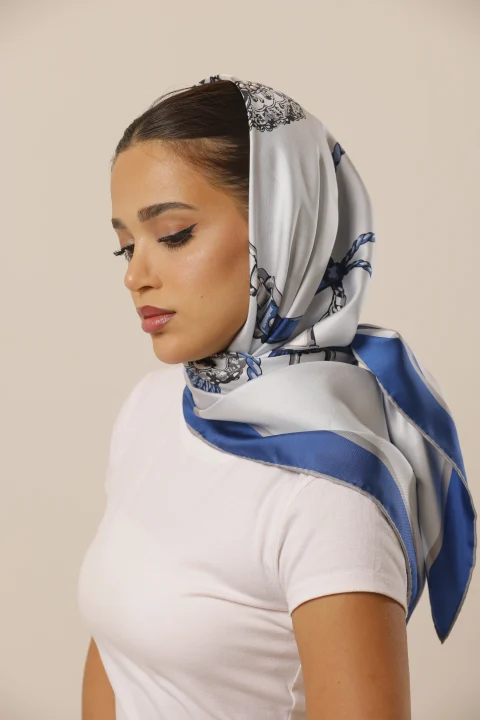 Azure Keepsake ivory and blue silk scarf worn around the head and neck