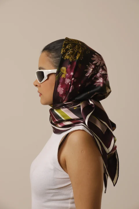 Evening Bloom burgundy floral silk scarf worn as a headscarf with white sunglasses