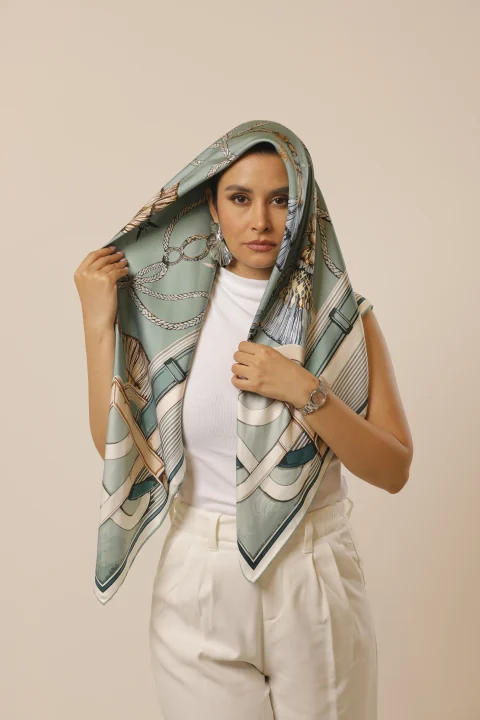 Mint Reverie held over the head, showing its mint print and cream border