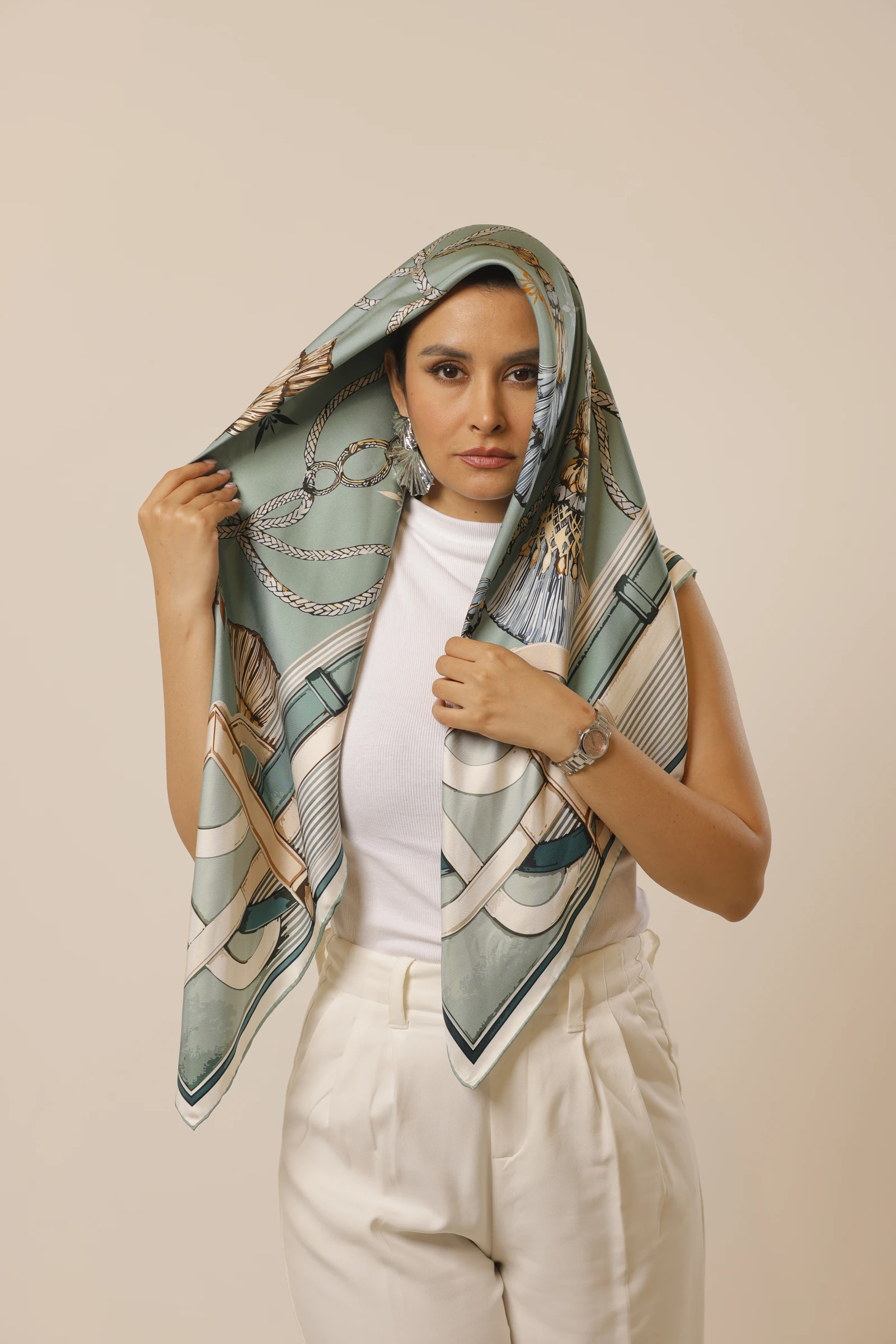 Mint Reverie held over the head, showing its mint print and cream border
