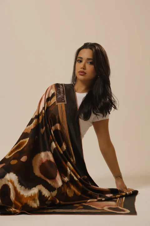 Wild Grace draped over one shoulder and spread across the studio floor