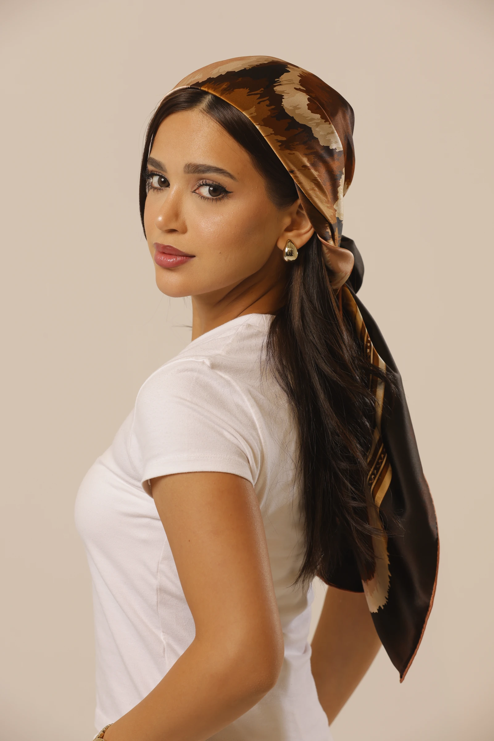 Wild Grace tied over the hair, with the model looking back